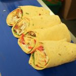 Four diagonally sliced wraps neatly cut by Millitec Ultrasonic Wrap Cutter