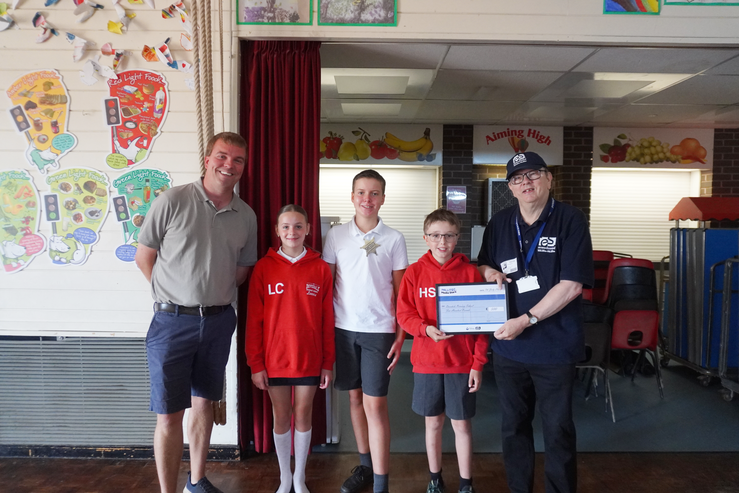 Dovedale Primary School prize presentation Jeff Martin, Station Manager at Erewash Sound, presenting a Media Starz runner-up prize to three students from Dovedale Primary School.